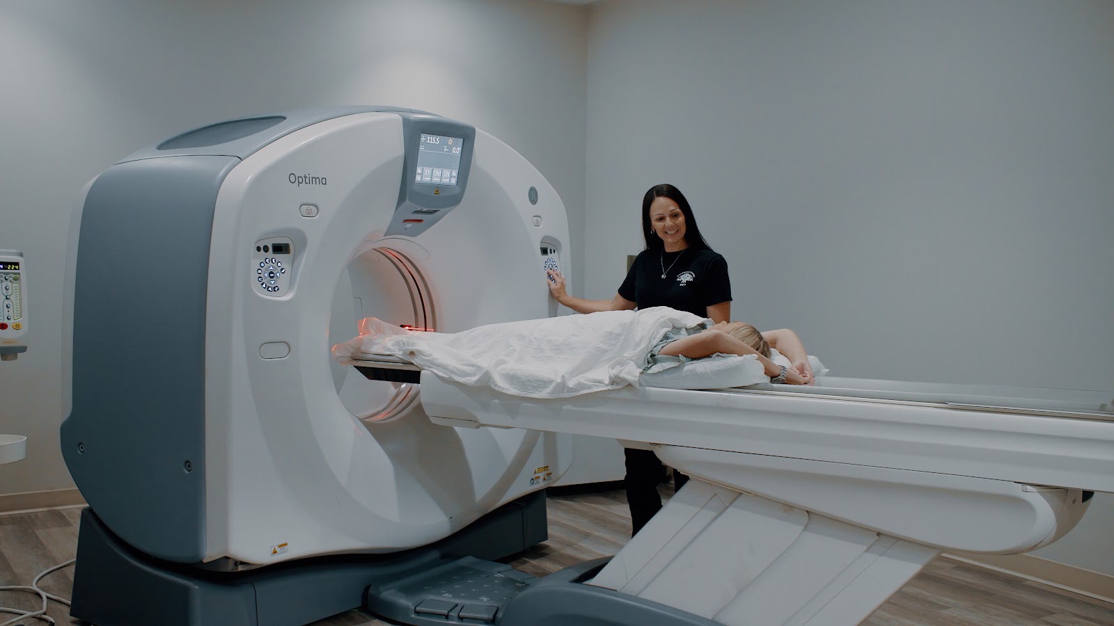 Friendswood Hospital ER technologist supporting a patient during a CT scan